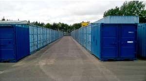 Tarmac roadways between steel storage containers.