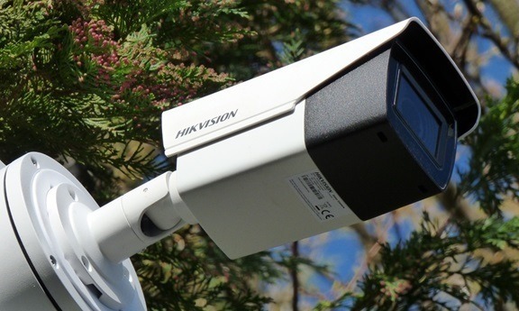 A cctv security camera fixed to a pole, monitoring movement around the storage depot.