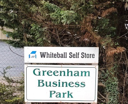 The main road entrance sign for Greenham Business Park and Whiteball Self Storage.